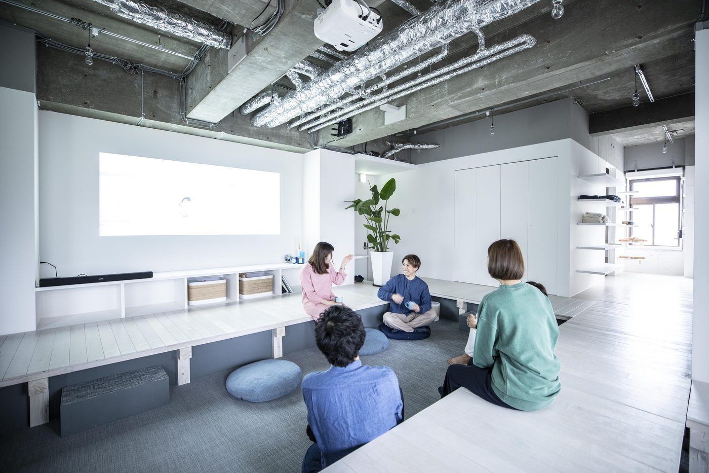 Residents relaxing in the shared living and coworking space at The Pier Coliving