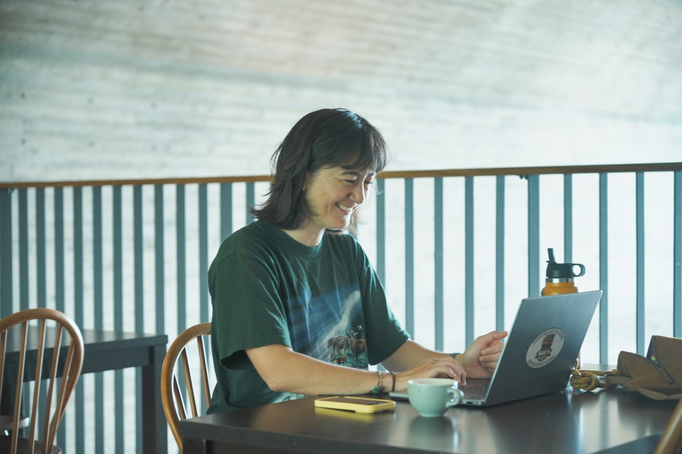 Resident working on a laptop at The Pier Coliving