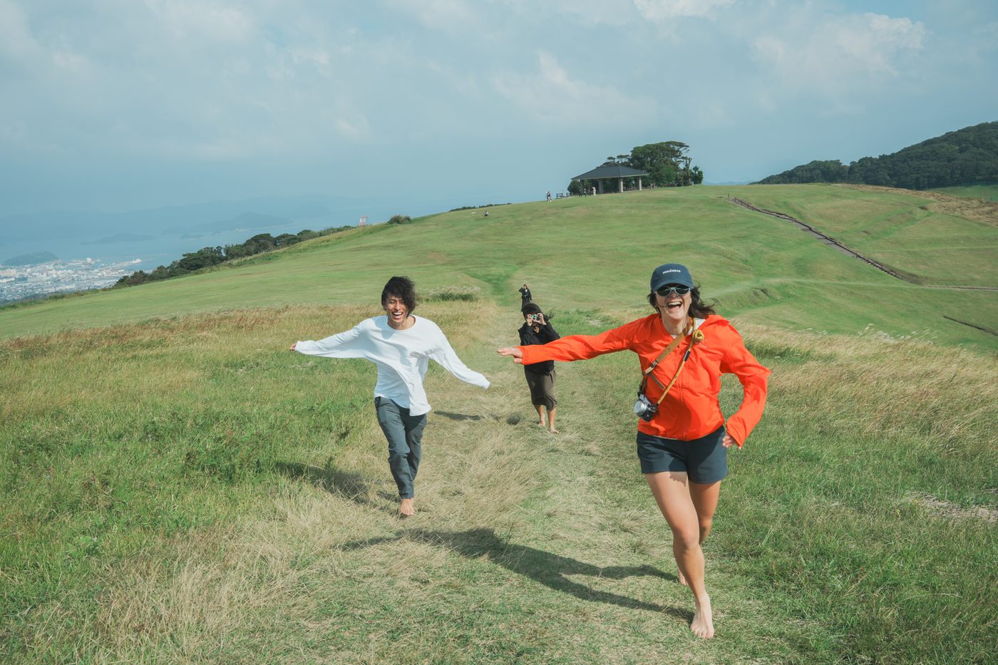 Residents running on the green hills of Onidake, Goto