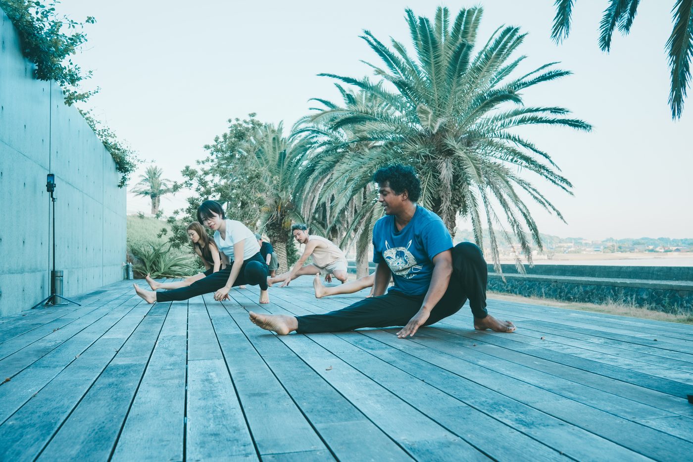 Morning yoga on the wooden deck by the sea
